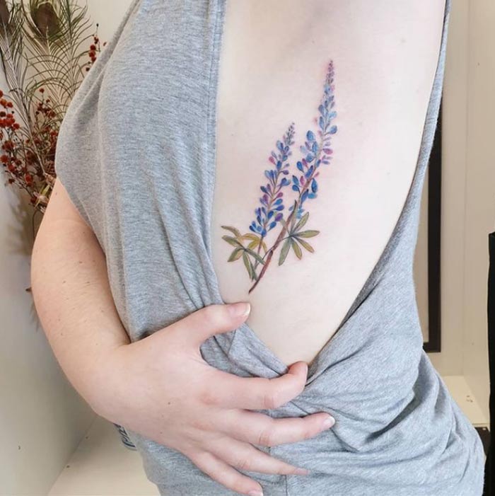 Floral watercolor tattoo design by Jess Hannigan