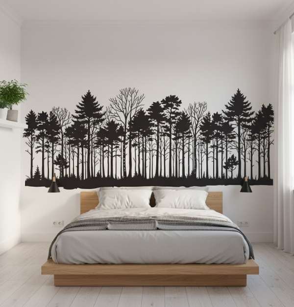 A stylish living room wall decorated with forest silhouette wall decals, adding a natural and modern touch to trendy home decor.