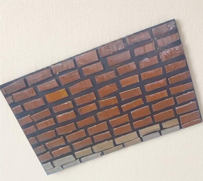 Handmade brick pattern created using small cardboard pieces painted brown for DIY wall decor step 4