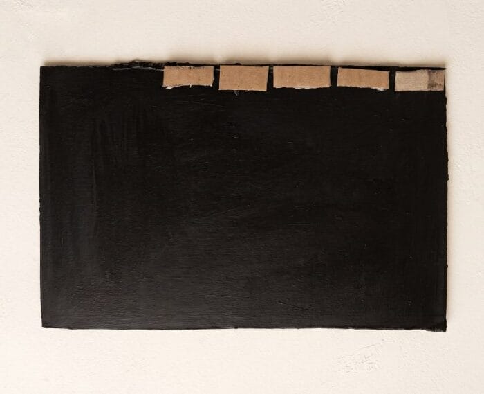 Black painted cardboard base prepared for cutting small pieces for wall decor craft step 3